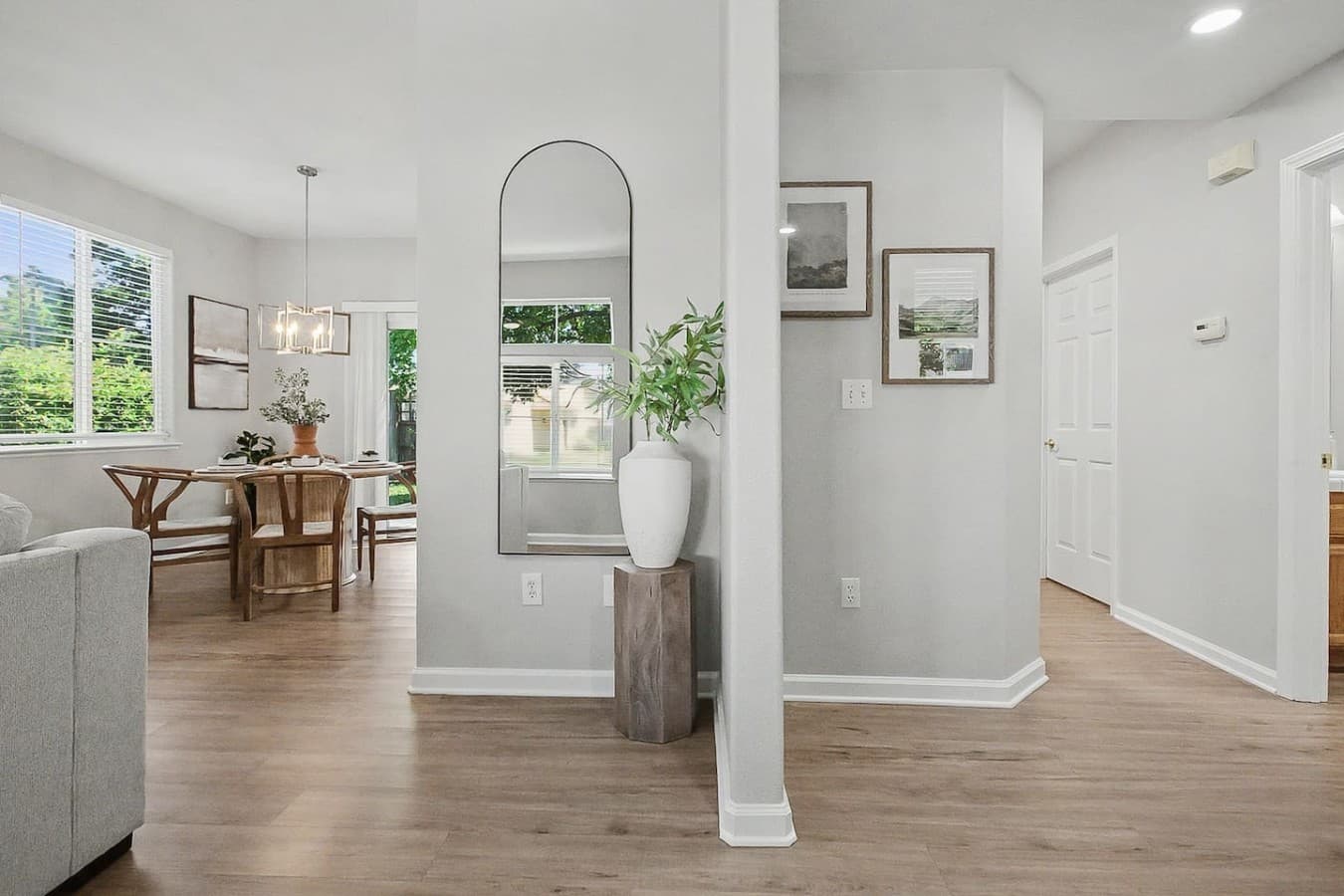 Open entry area leading into the dining and living spaces with warm neutral tones.