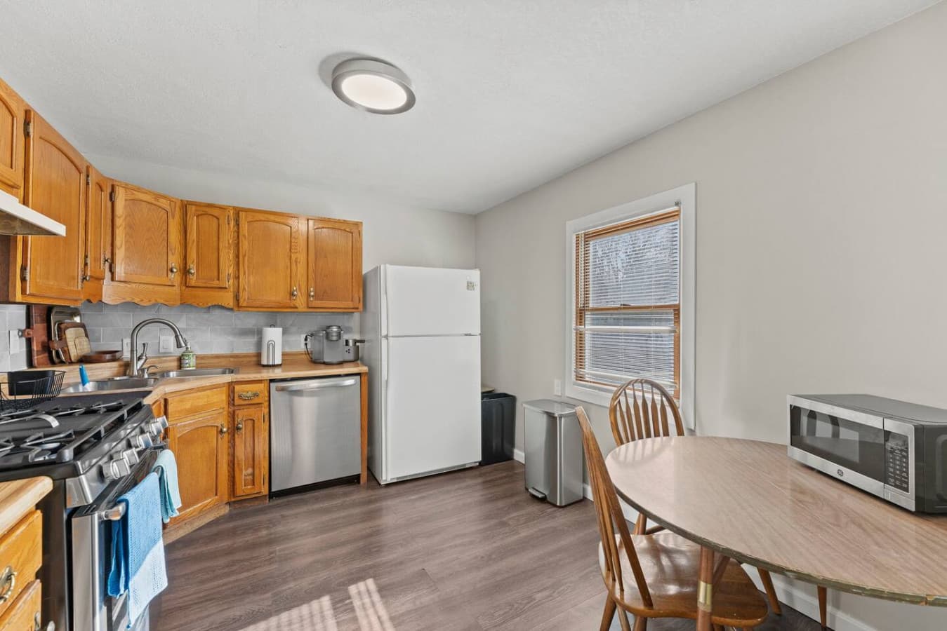 Sunlit kitchen and dining area with ample space to gather and enjoy meals.