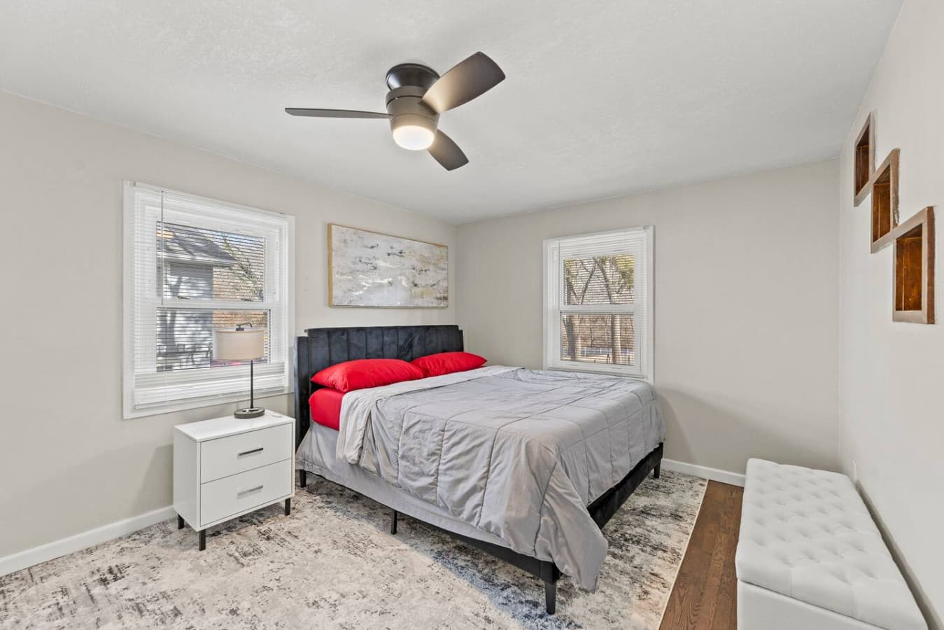 Bright bedroom with plush bedding and soft natural light throughout.
