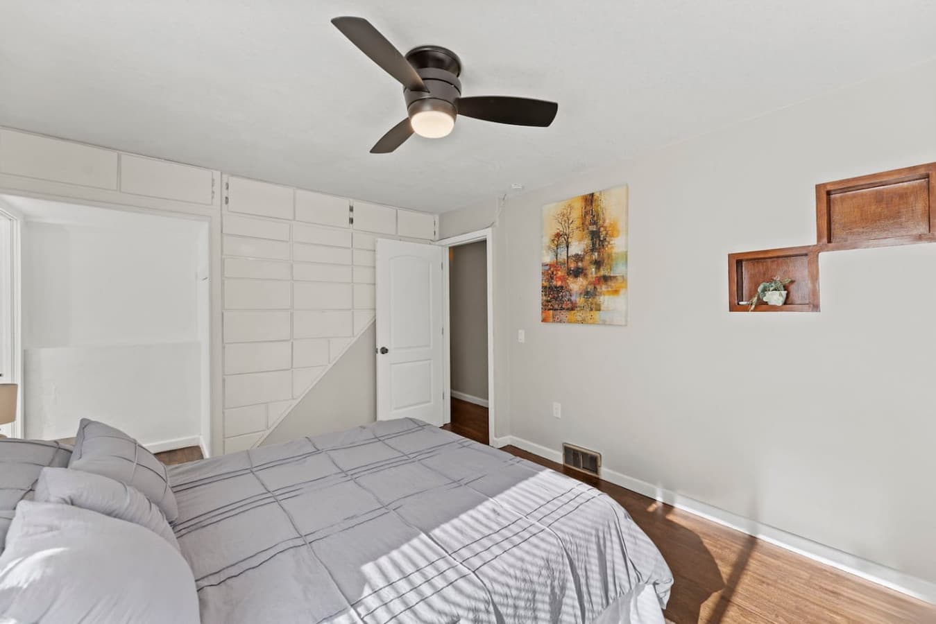 Simple and relaxing bedroom with thoughtful touches and ample storage.