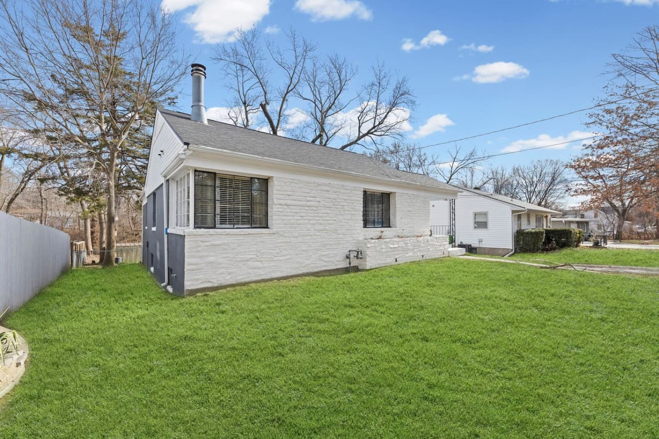 Single level living surrounded by mature trees and open green space.