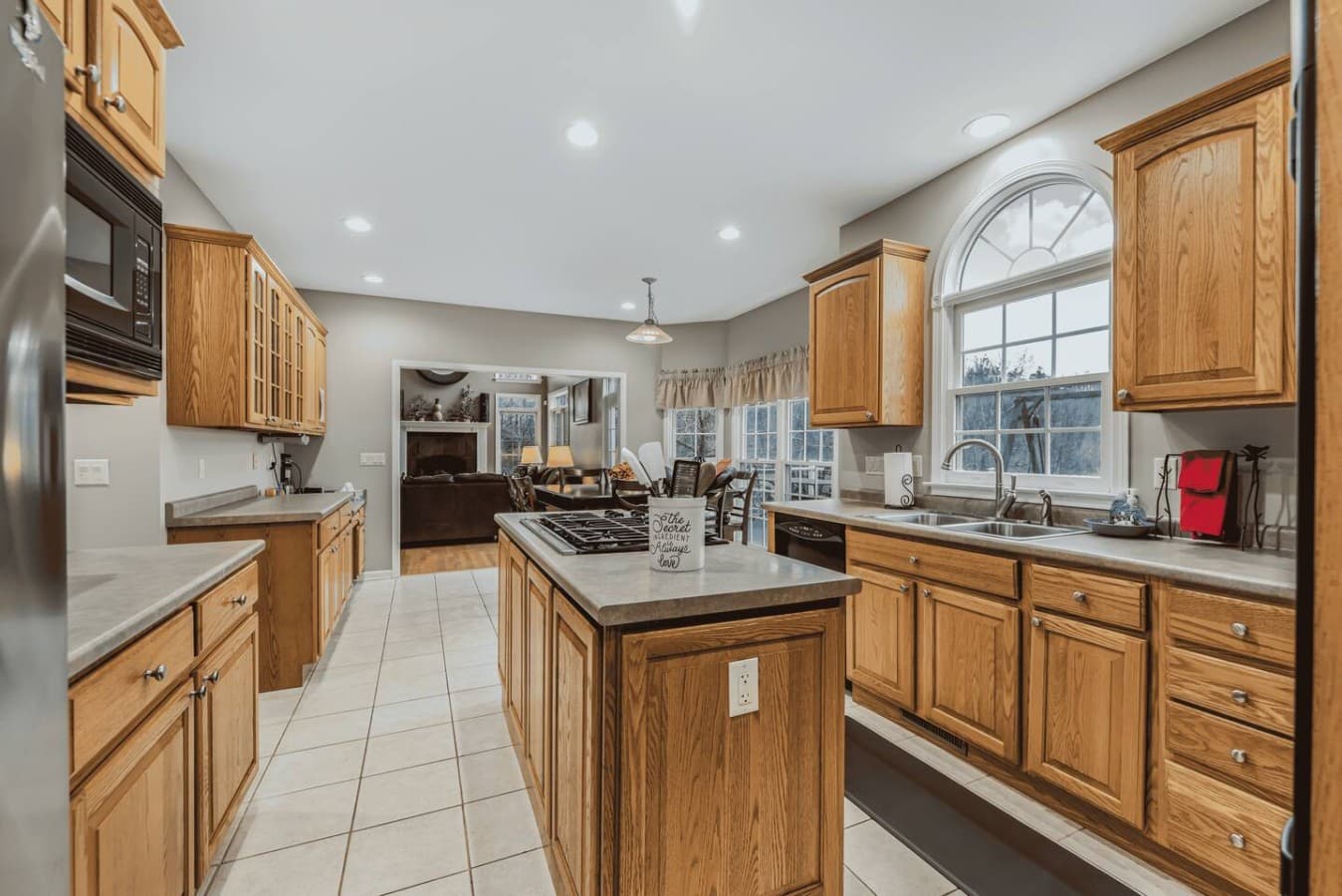 Spacious kitchen with warm wood cabinetry, ample counter space, and natural light throughout.