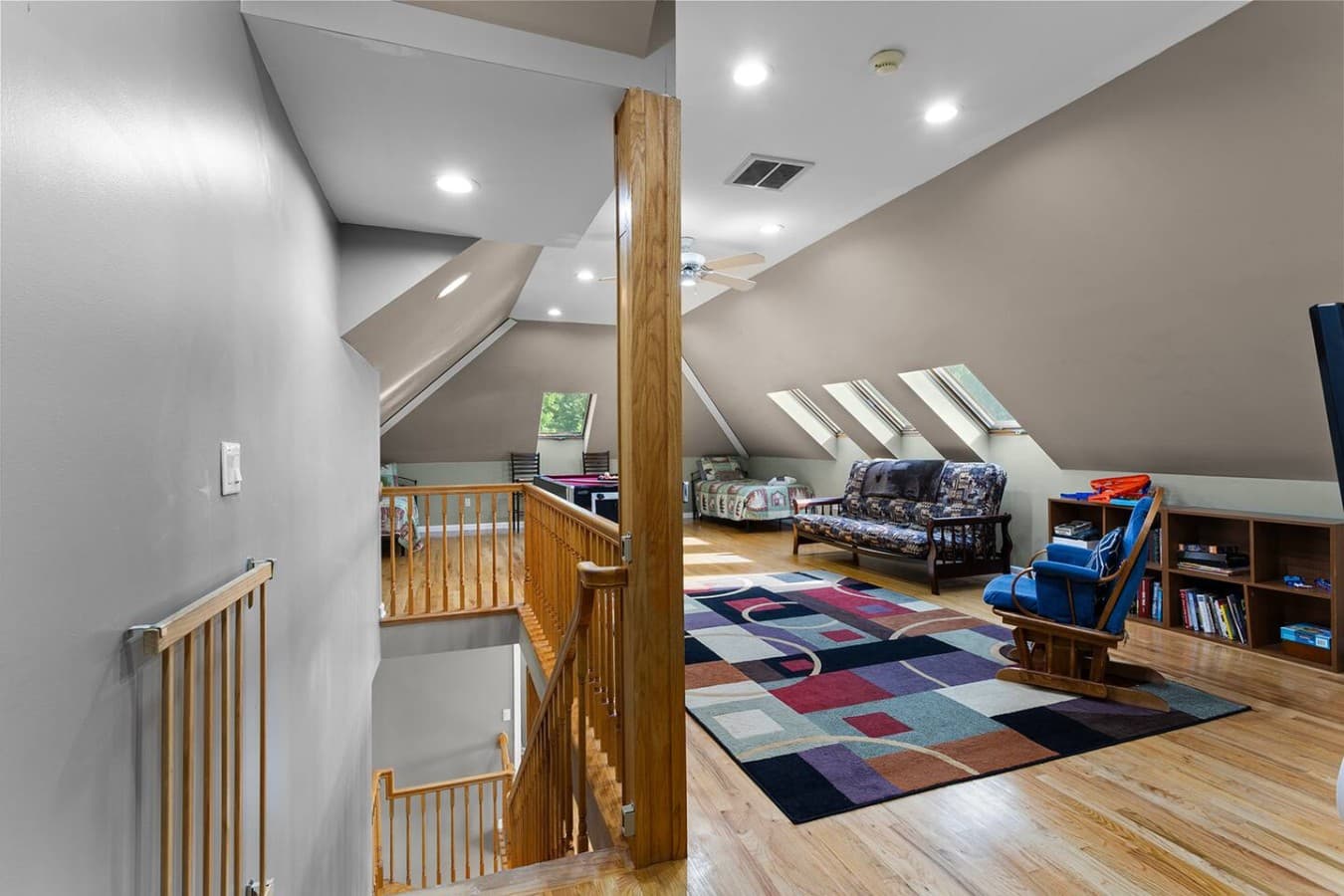 Open upper level with vaulted ceilings, cozy seating, and a spacious entertainment area.