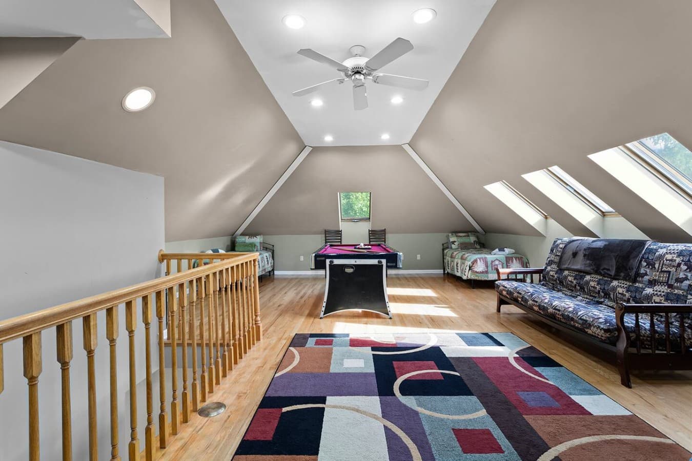Large loft game room with pool, lounge seating, and extra space for gathering together.