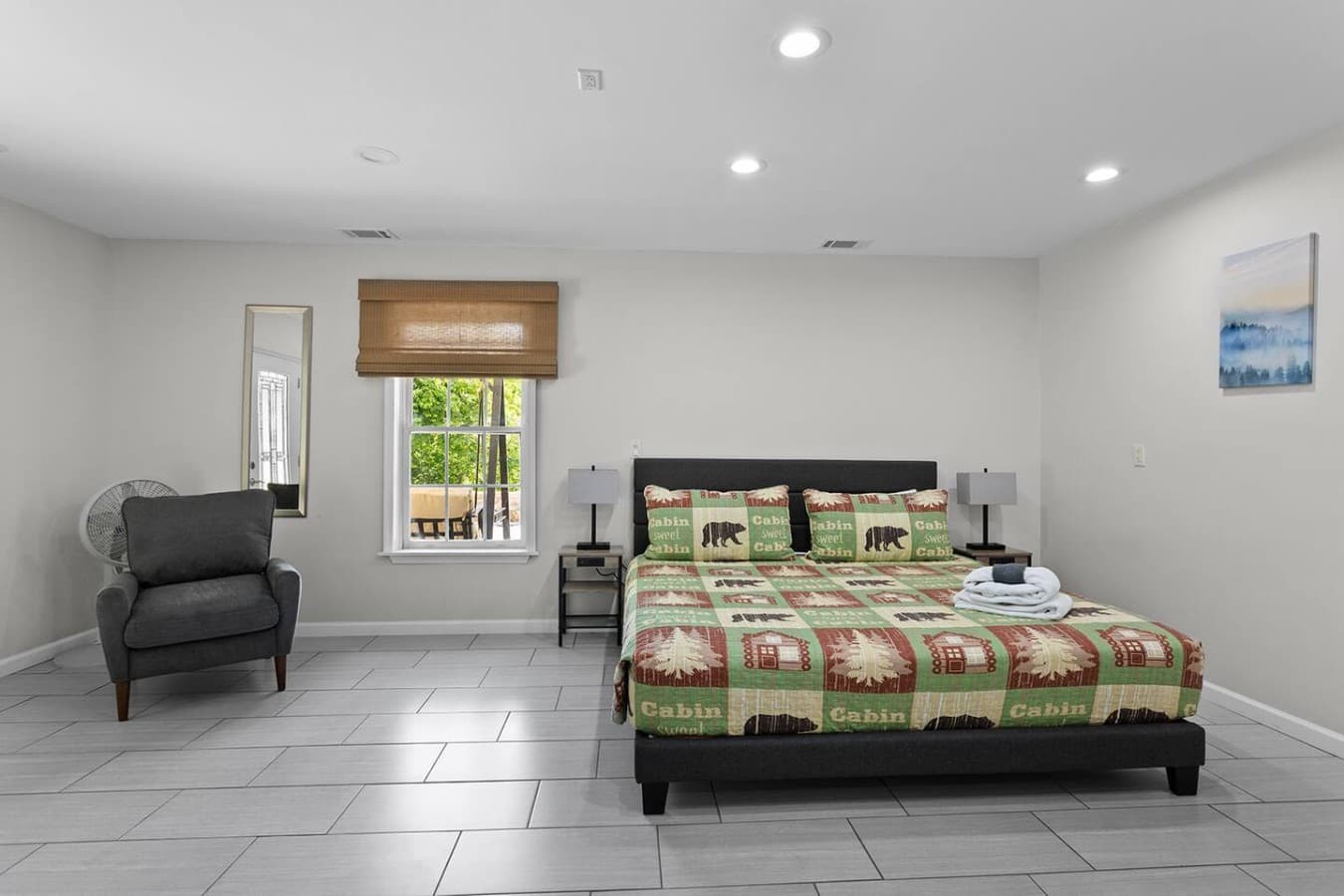 Private lower level bedroom suite with comfortable accommodations and natural light.