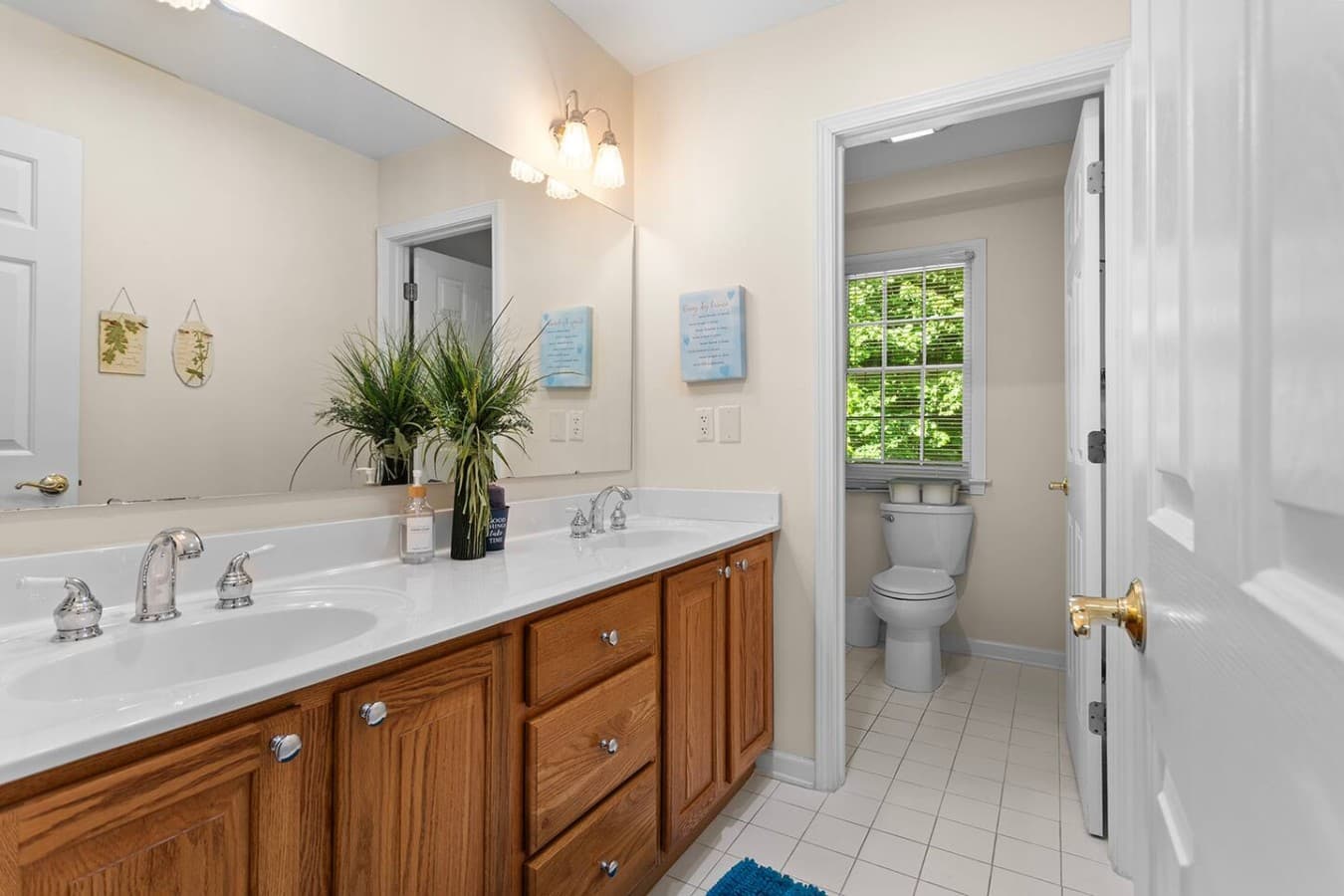 Full bathroom with double vanities and plenty of space for getting ready.