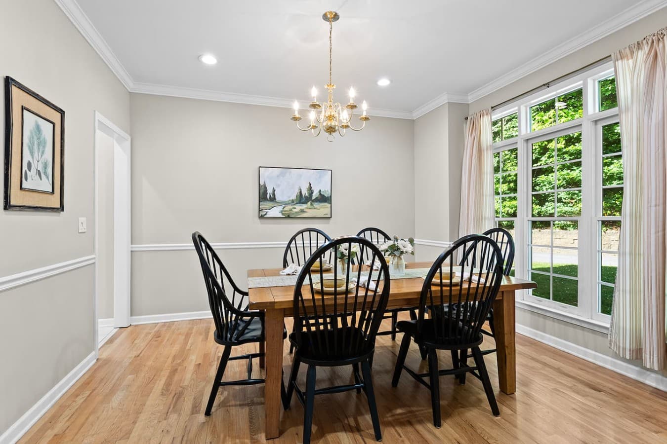 Formal dining room with natural light and a cozy setting for family dinners.