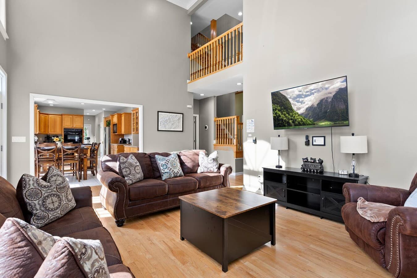 Open concept living room with soaring ceilings and comfortable seating for relaxing together.