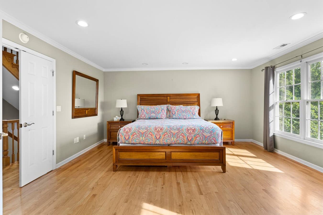 Spacious bedroom with warm natural light and a peaceful retreat feel.