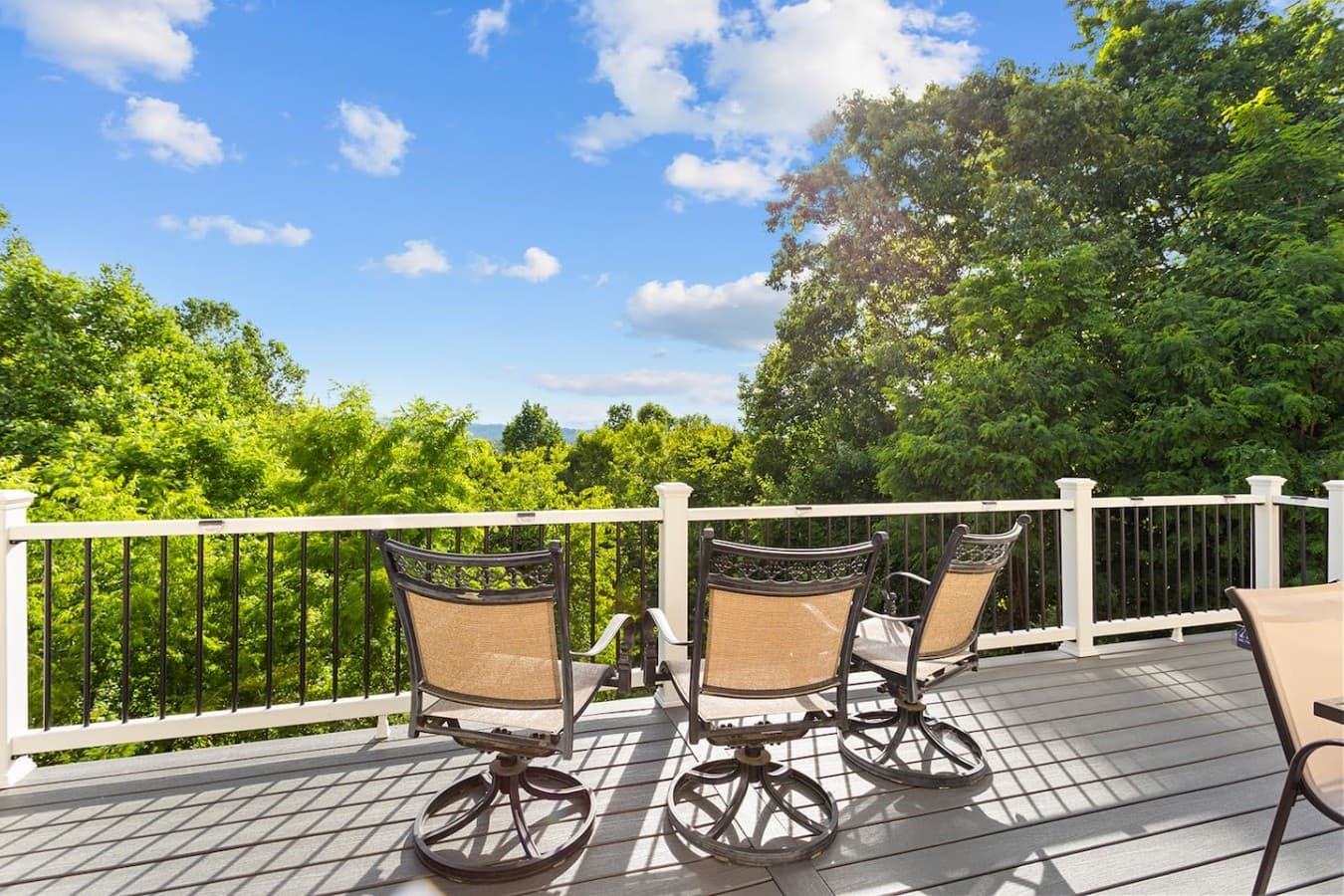 Private outdoor seating area with peaceful wooded and mountain views.
