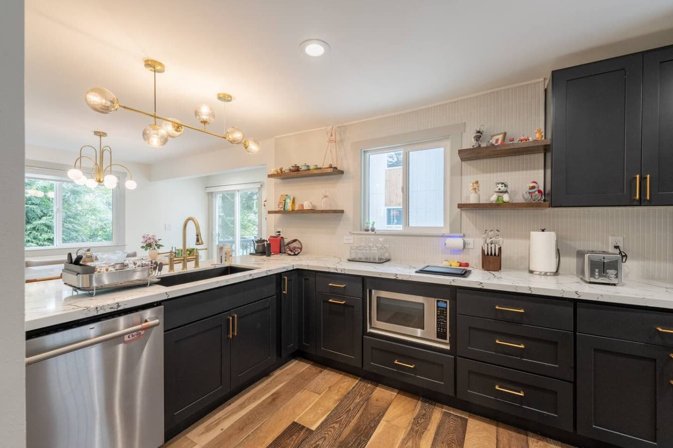 Bright and stylish kitchen featuring quartz countertops, open shelving, and warm modern finishes throughout.