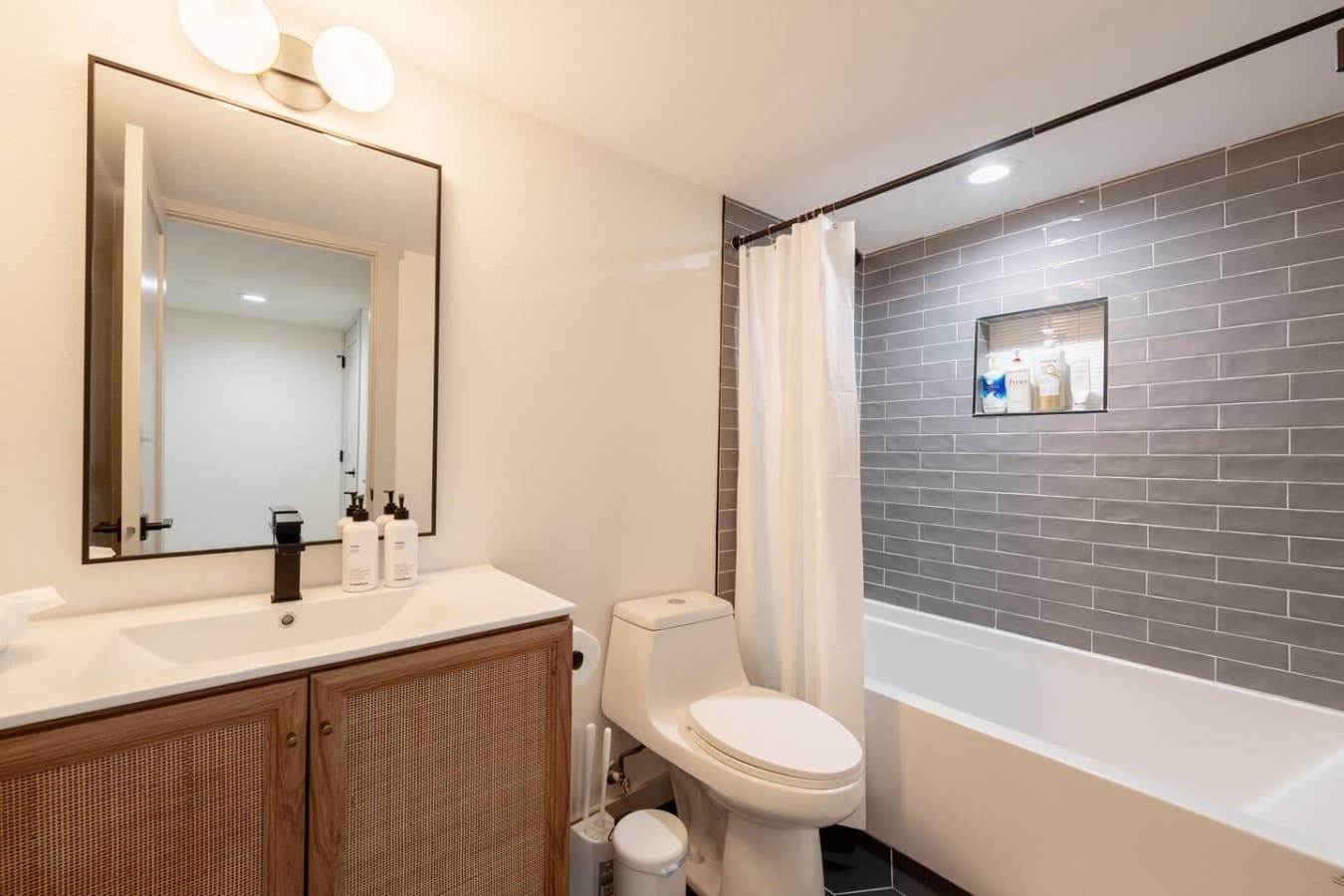 Bathroom Bliss: Relax in this sleek retreat with modern fixtures and soothing tones!