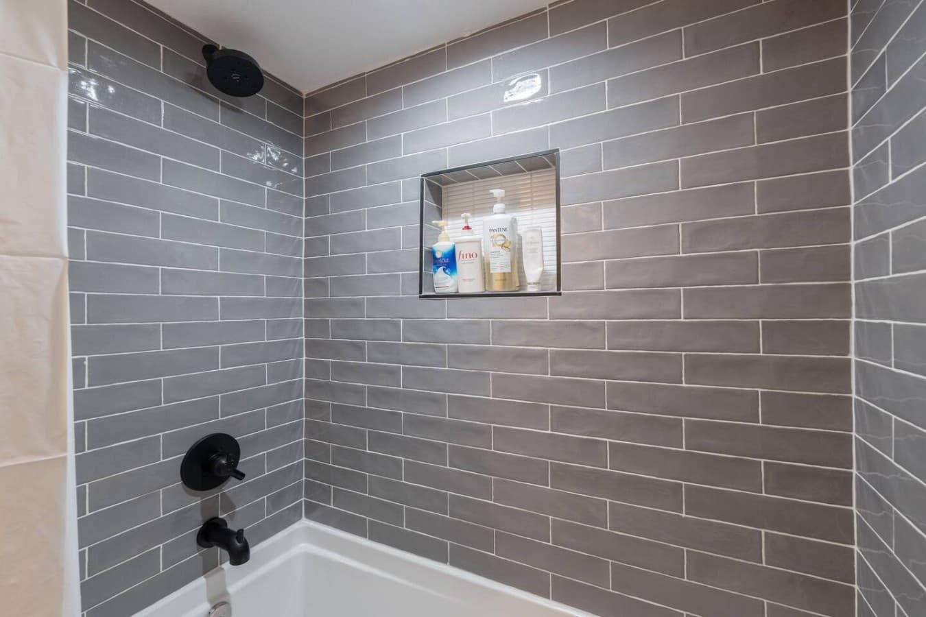 Modern tiled shower and tub combo featuring sleek finishes and a fresh spa like atmosphere.