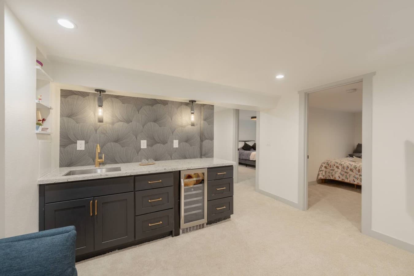 Stylish lower level wet bar and lounge area perfect for movie nights, drinks, and entertaining indoors.