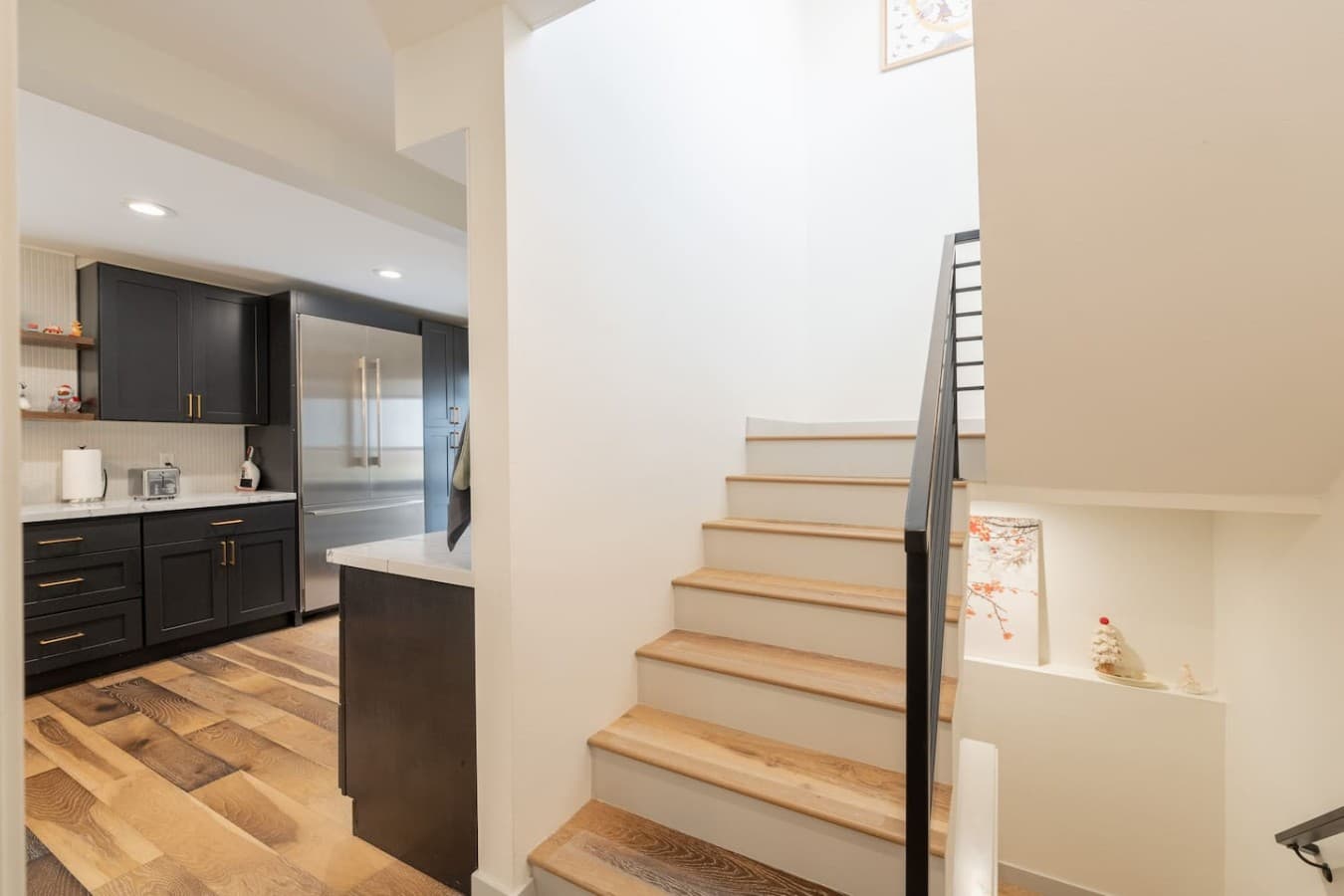 Open staircase and hallway connecting the home’s spacious living areas across multiple levels.