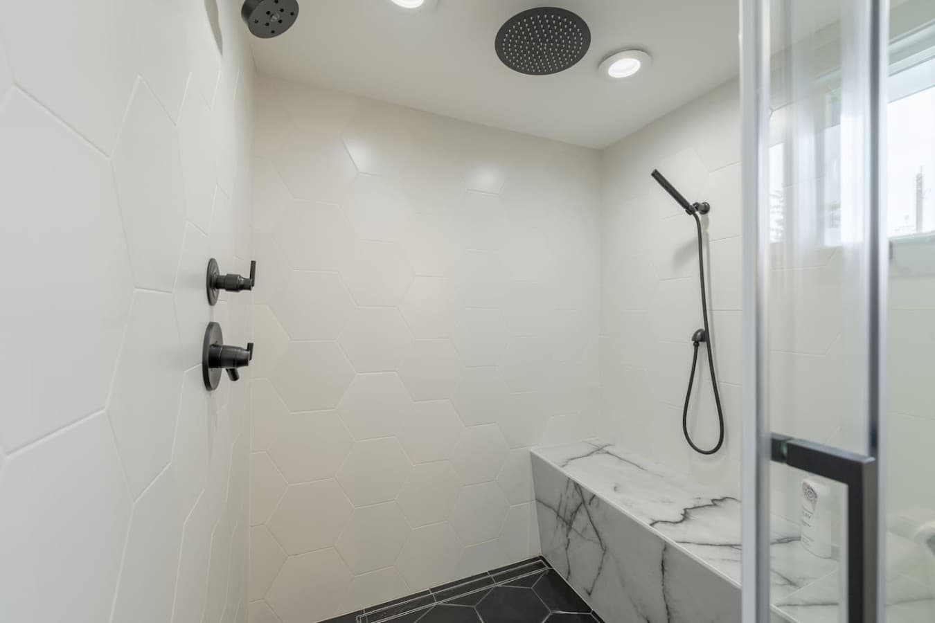 Spa inspired bathroom with a luxurious walk in shower, rainfall showerhead, and sleek modern finishes.
