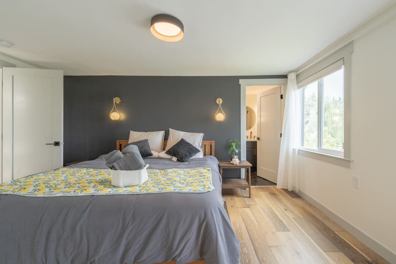 Peaceful bedroom retreat featuring soft lighting, natural light, and a calming modern design.