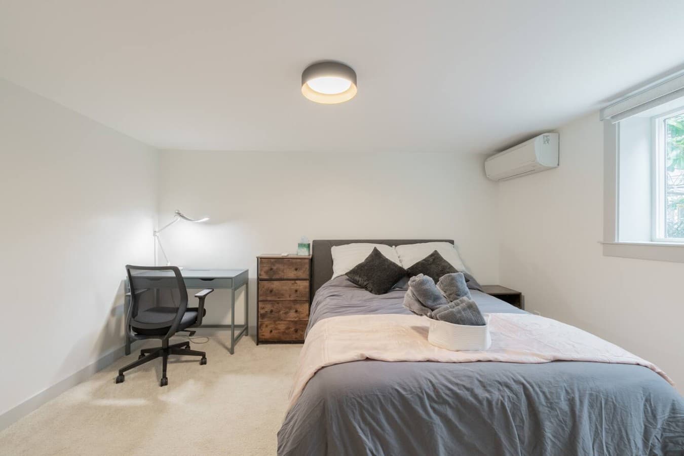 Comfortable bedroom with a dedicated workspace, cozy bedding, and a clean modern design for relaxing stays.
