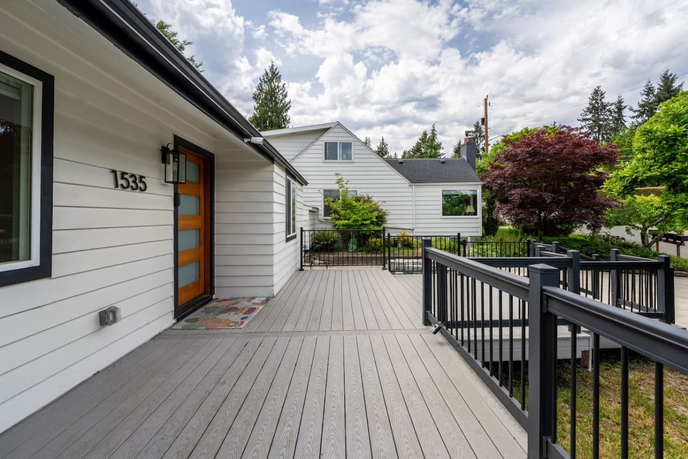 Large front deck with modern design details and outdoor space to relax and unwind.