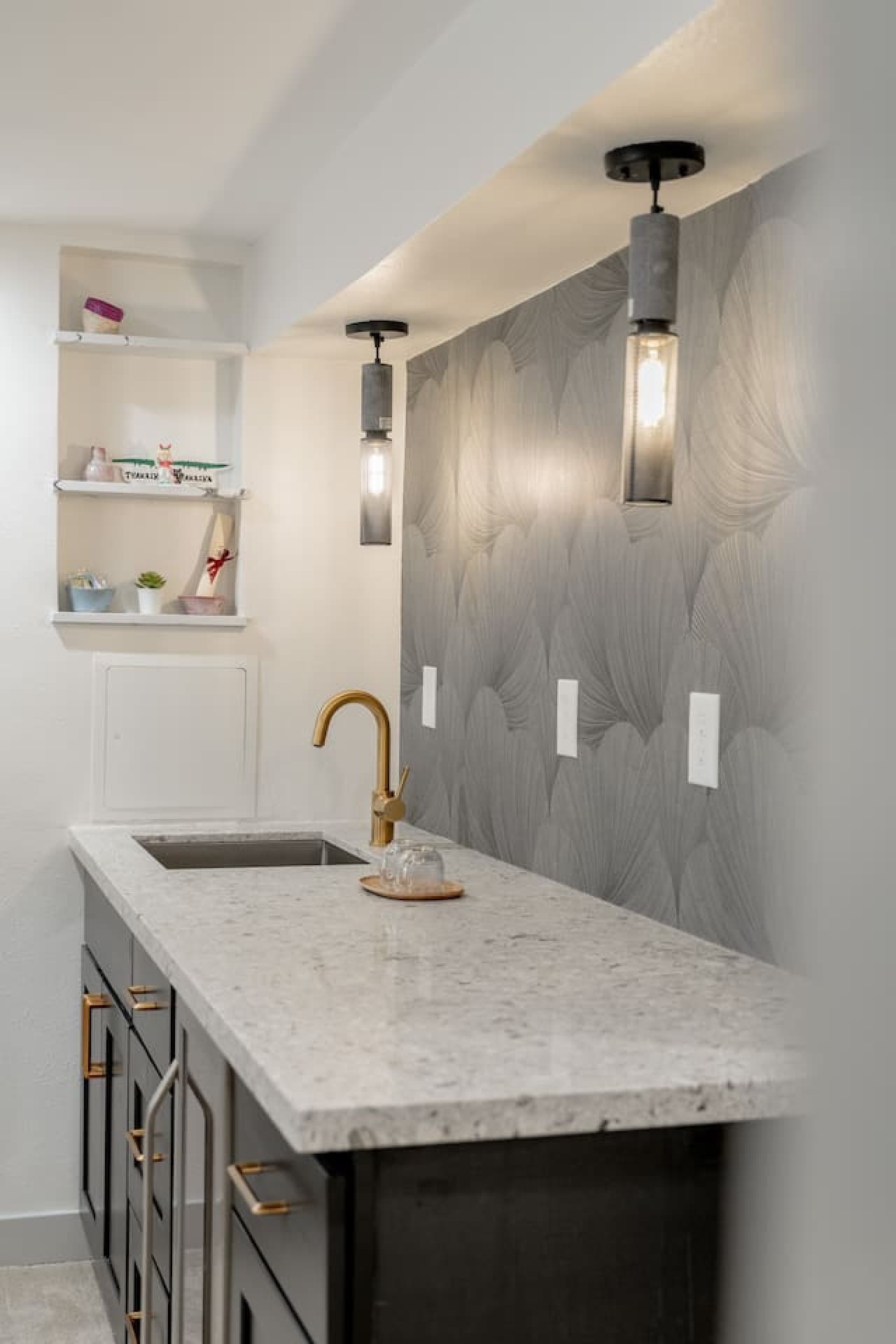 Additional lower level wet bar with mini fridge and extra counter space perfect for drinks and snacks.