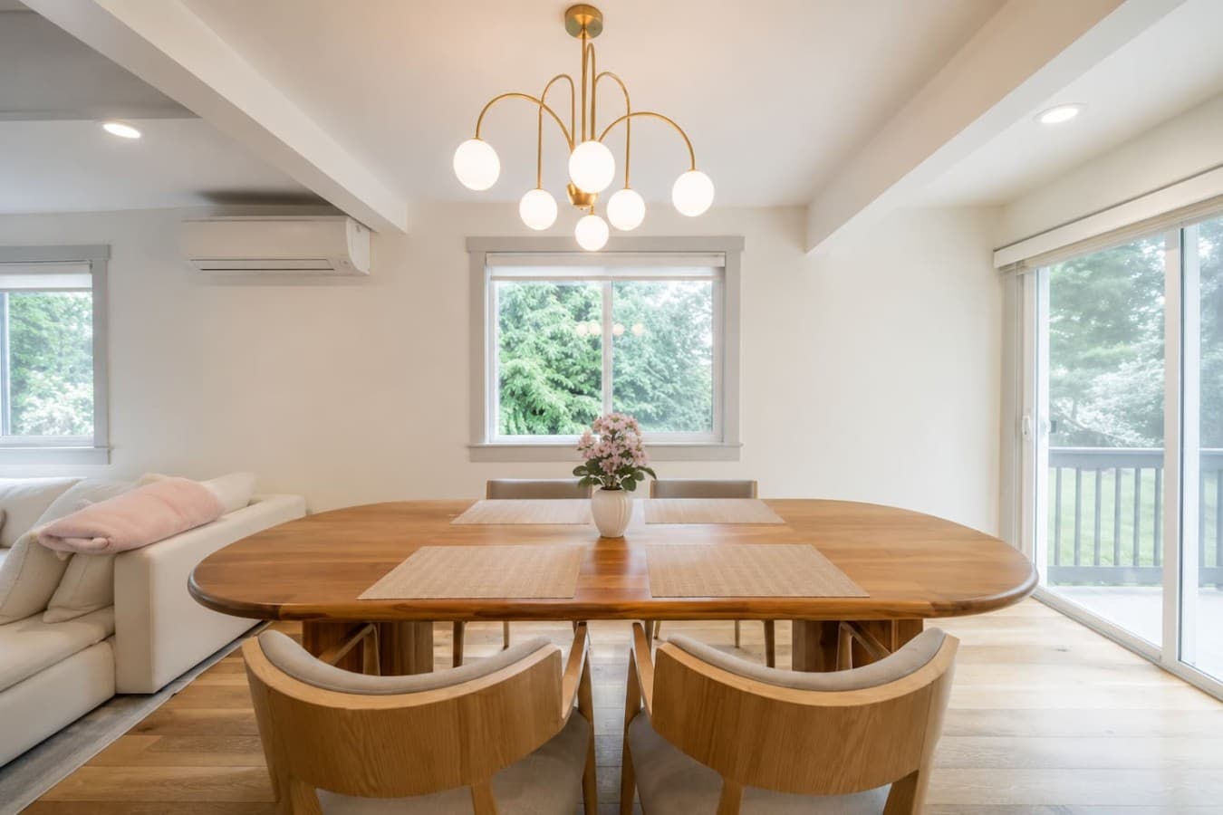 Bright dining space with large windows, modern lighting, and a cozy atmosphere for morning coffee or dinner together.