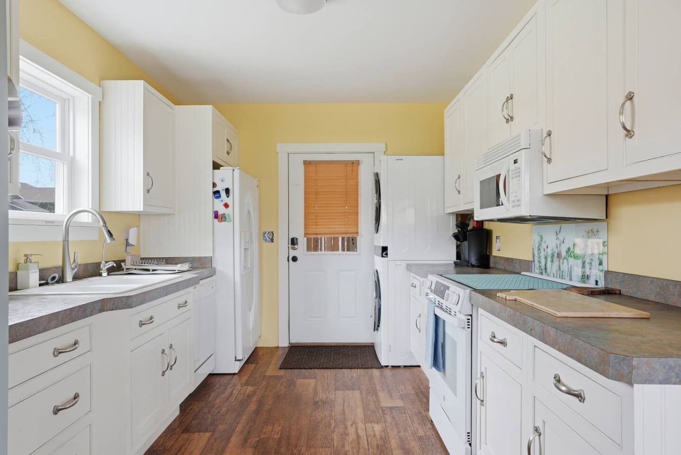Bright cheerful kitchen with full size appliances and ample counter space.