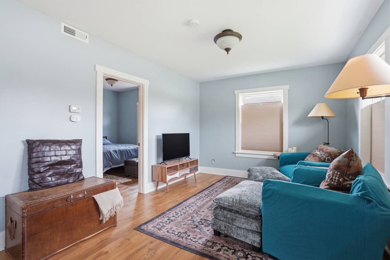 Cozy lounge space with smart TV and easy flow into the bedroom.