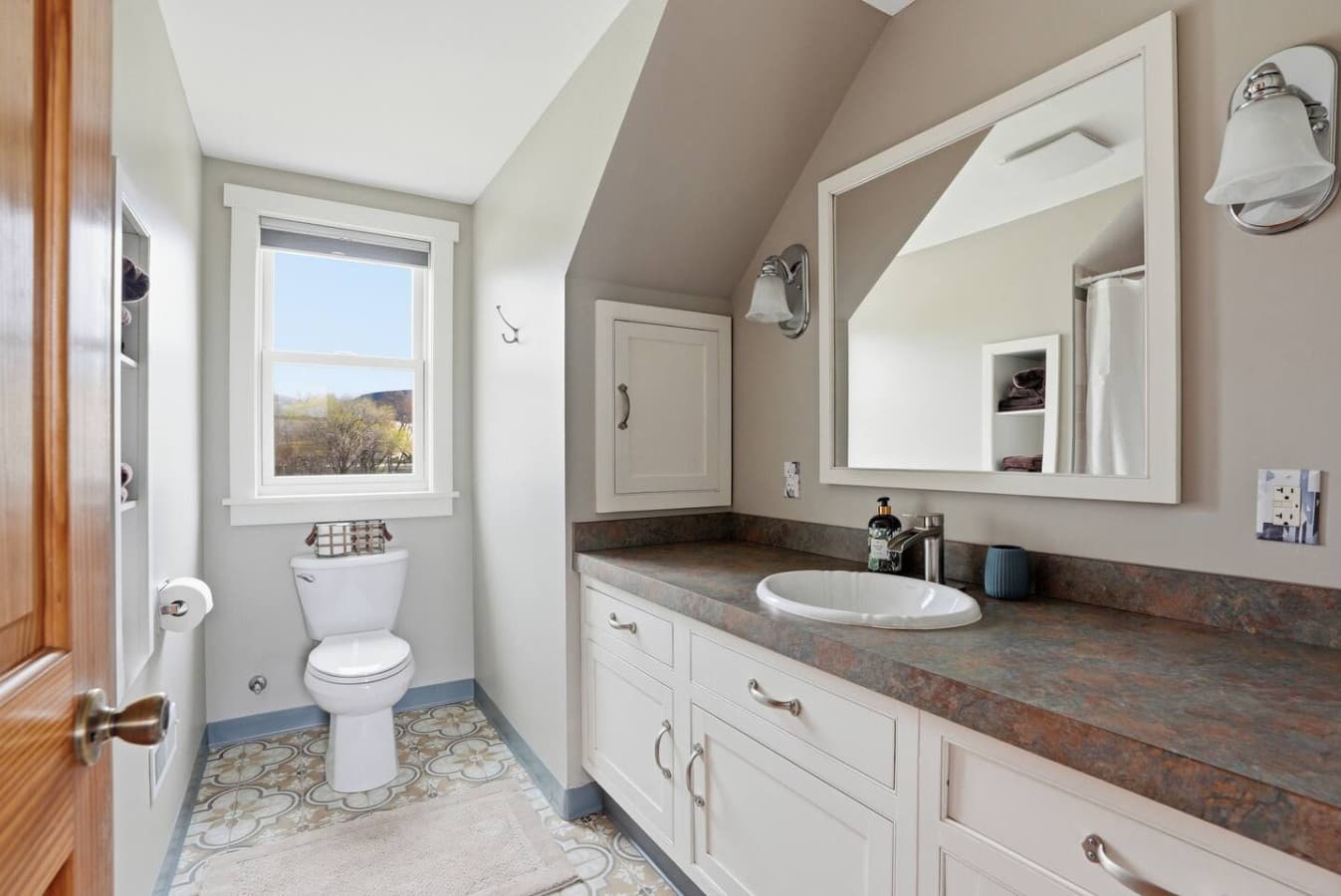 Bright bathroom with large vanity and natural light.