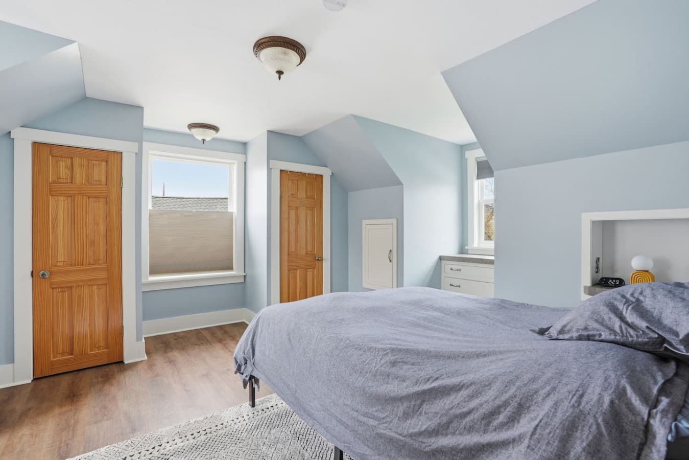 Comfortable sleeping space with calming colors and cozy bedding.