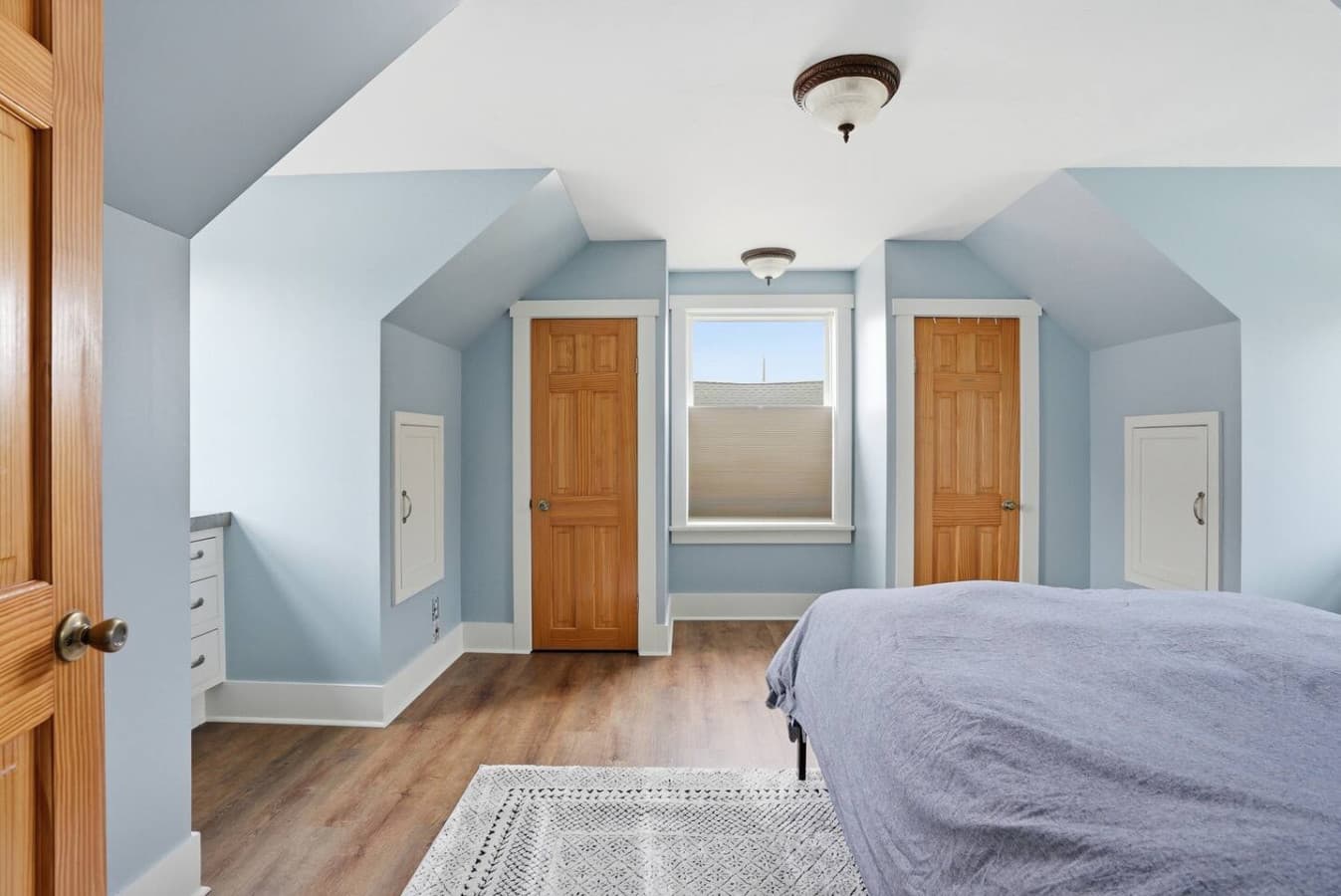 Spacious bedroom with vaulted ceilings and soft natural light.