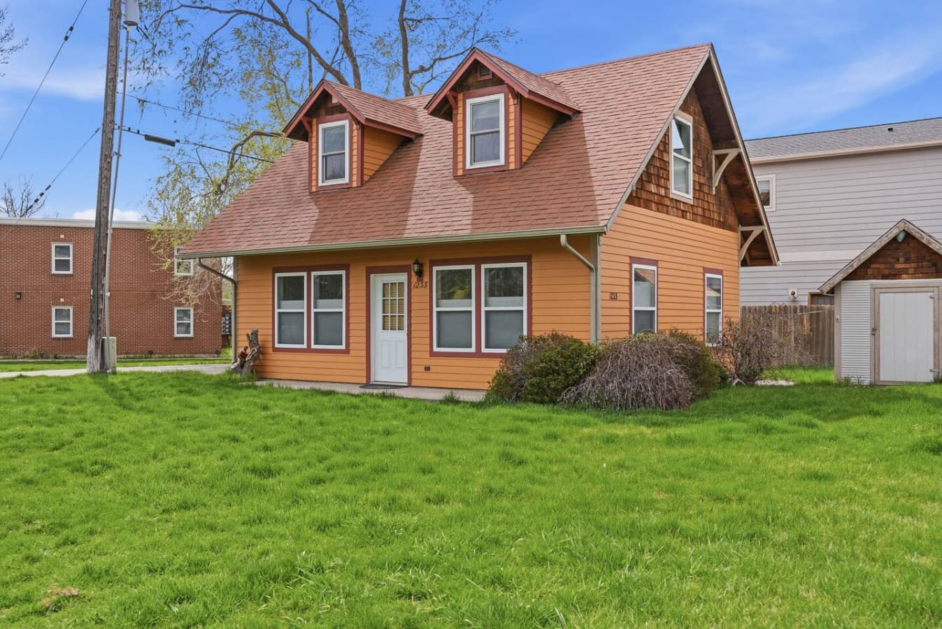 Cozy standalone home surrounded by open green space.