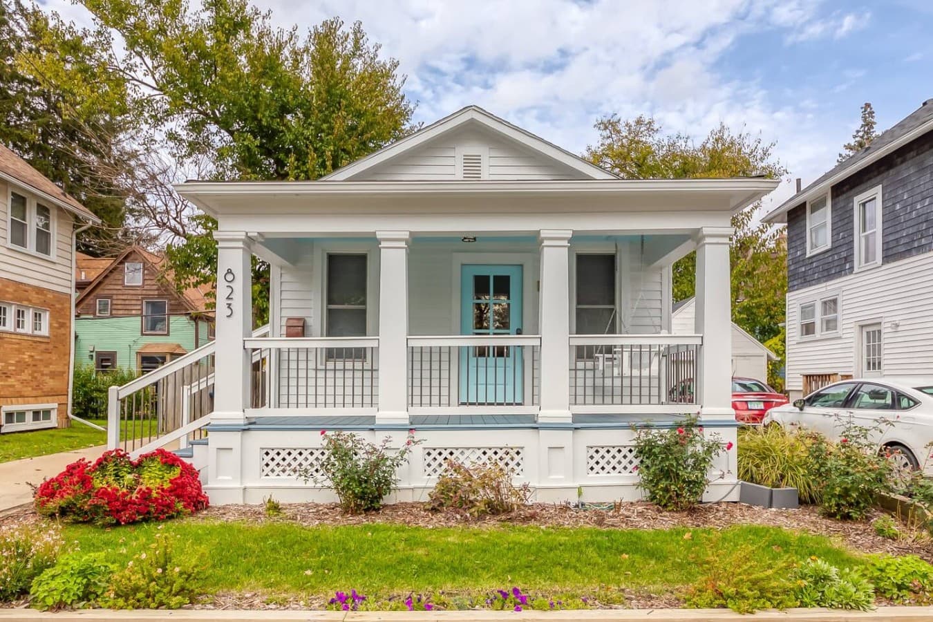 Charming cottage exterior with a welcoming front porch and peaceful neighborhood setting.