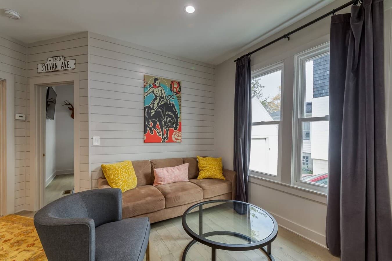 Comfortable lounge space with modern artwork and plenty of sunlight.