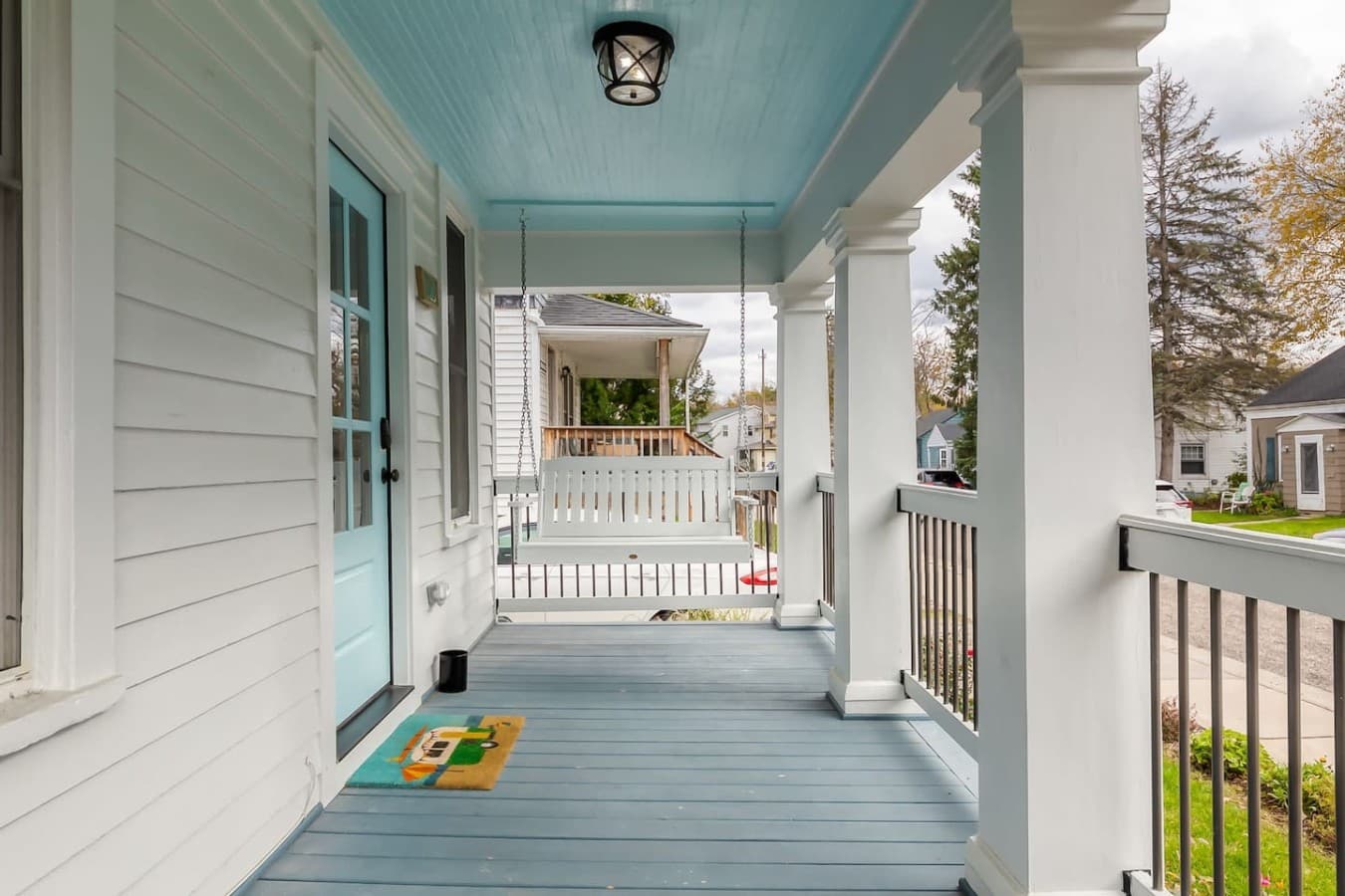 Spacious front porch with cozy seating and classic cottage charm.
