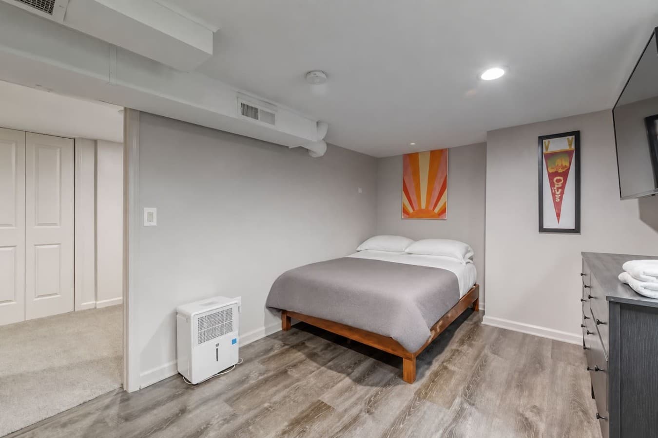 Cozy bedroom with a plush queen bed and calming neutral tones.