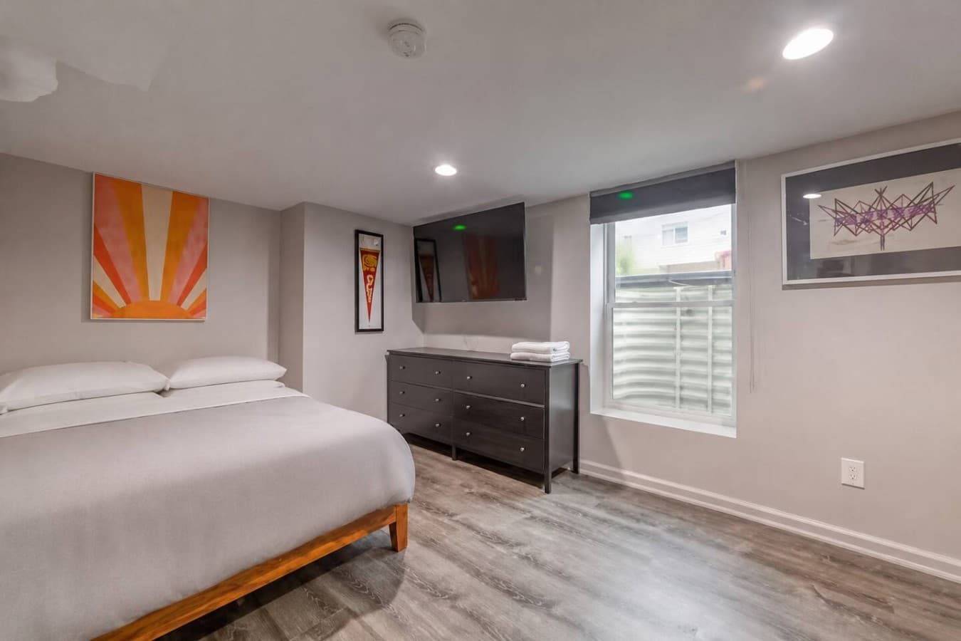 Smart TV and dresser setup for comfortable extended stays.