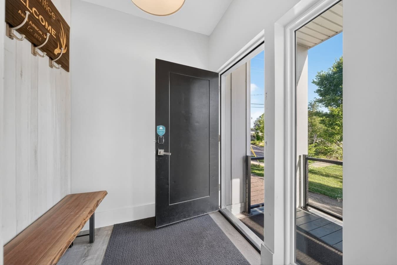 A warm welcome awaits with a convenient entryway featuring seating and coat hooks.