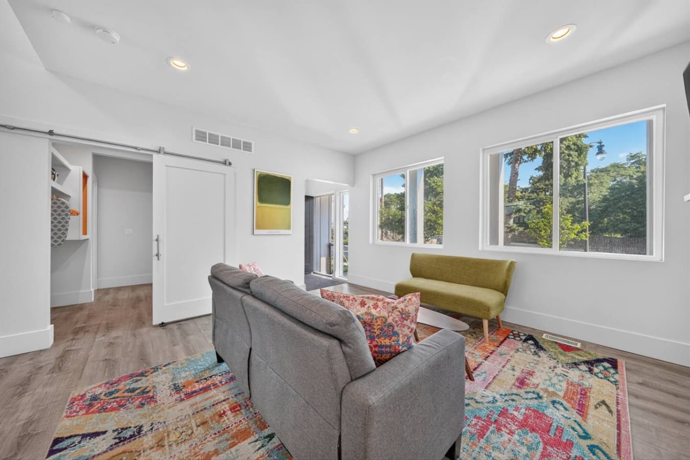 Bright and comfortable living room with large windows that fill the space with natural light.