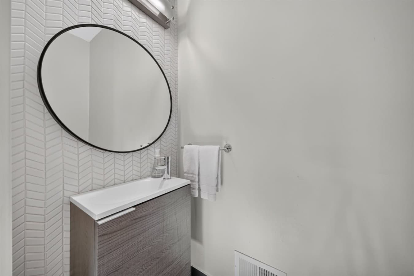 Fresh and functional half bathroom for added comfort.