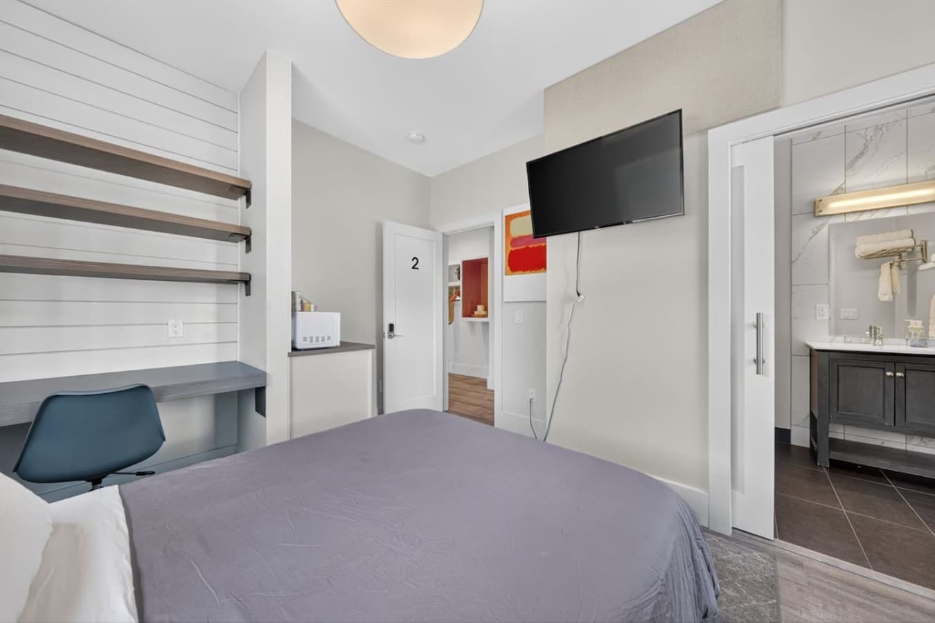 Enjoy a cozy night's sleep in a thoughtfully furnished bedroom with soft bedding and modern finishes.