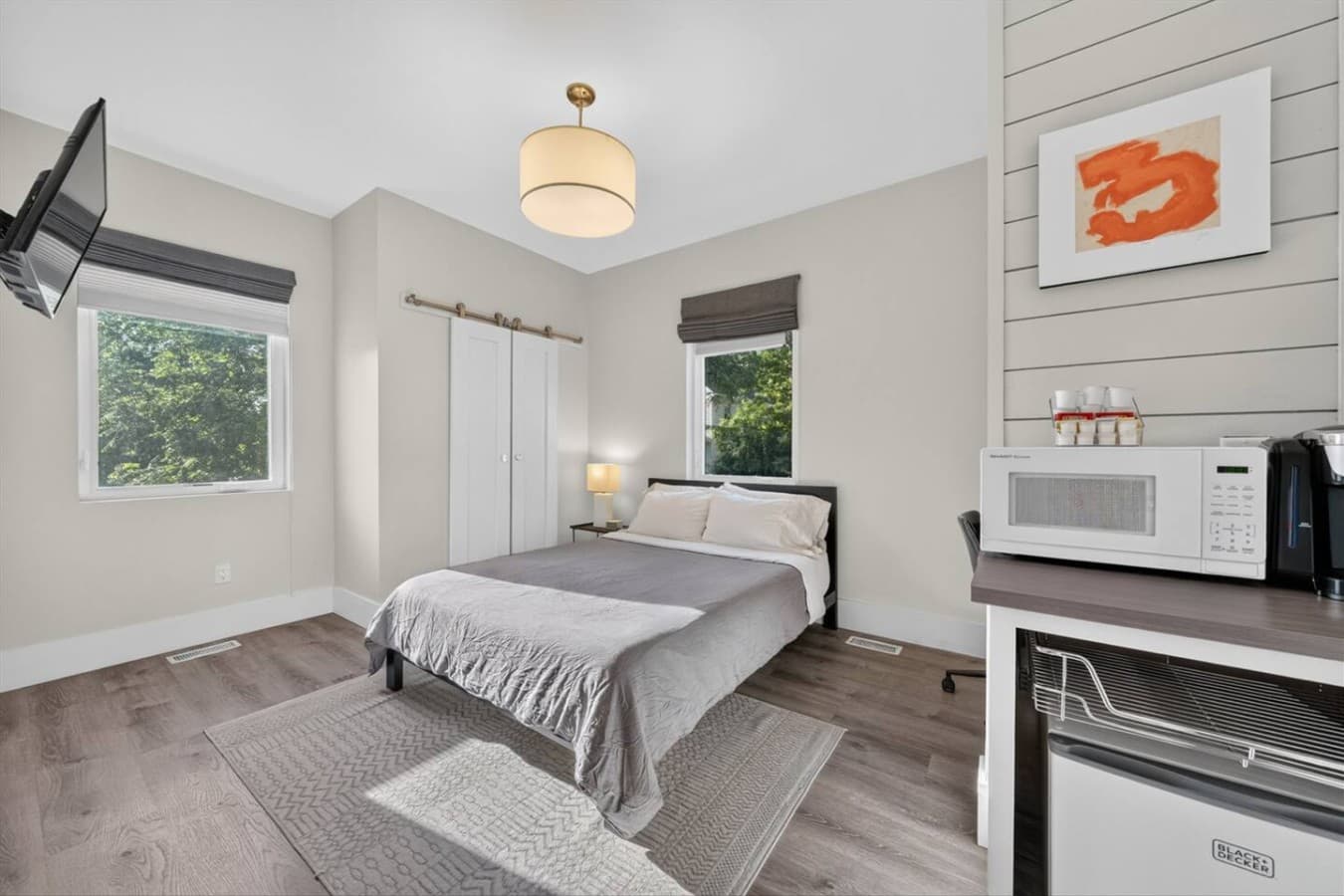 Recharge in a cozy queen bed featuring hotel-quality linens and sheets