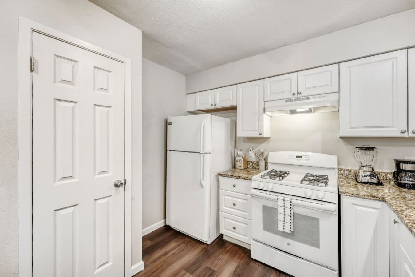 Kitchen with refrigerator and gas stove.