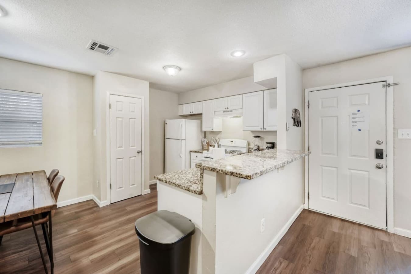 Open kitchen with breakfast bar seating.