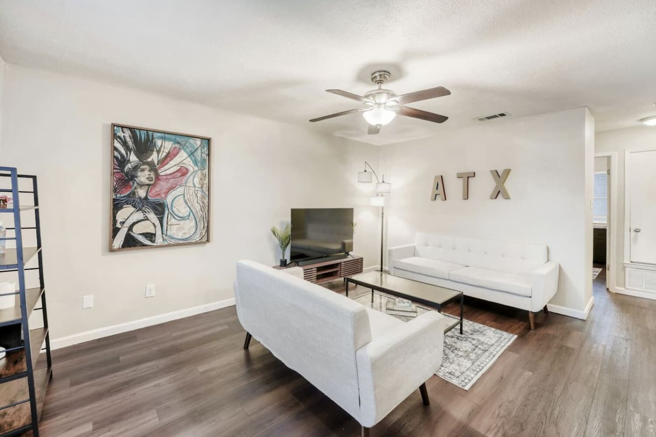 Living room with artwork and seating.