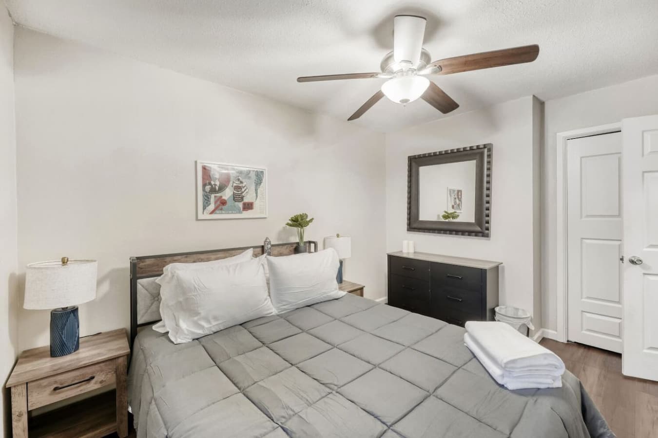Bedroom with dresser and ceiling fan.