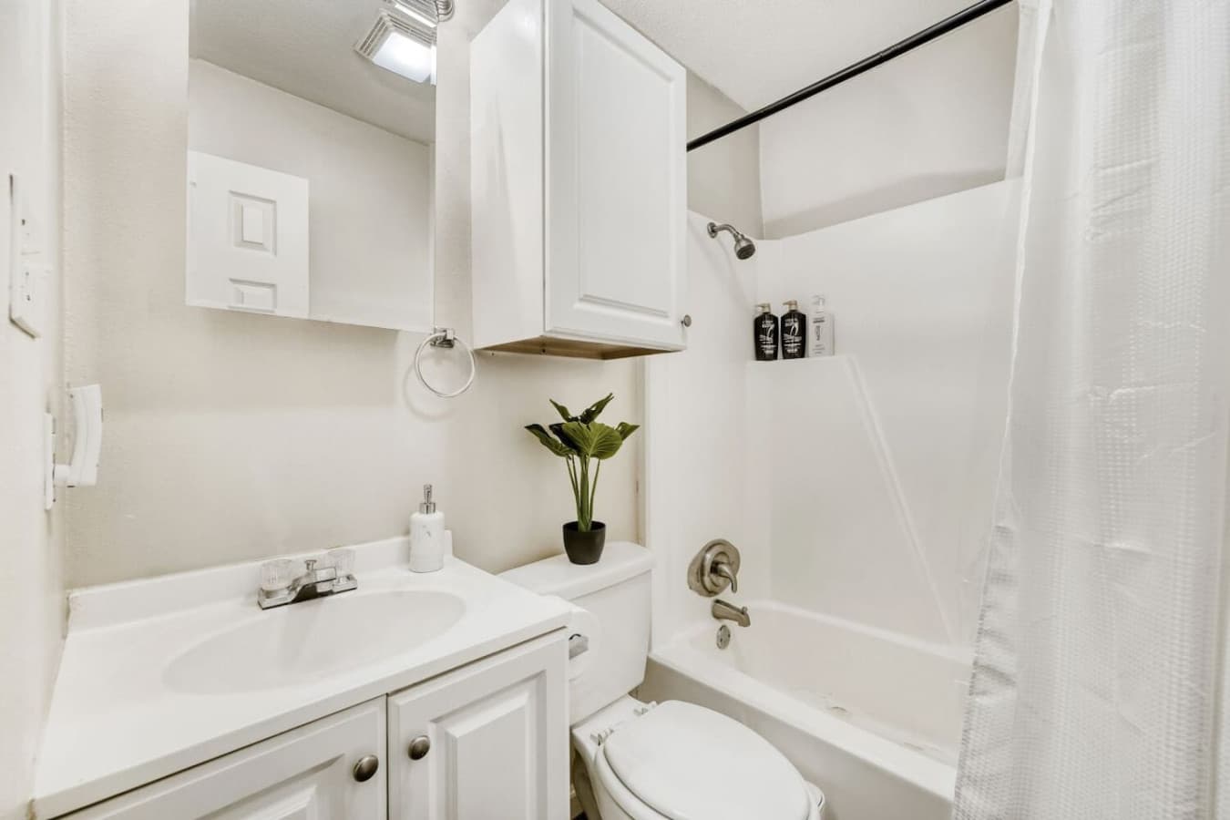 Clean bathroom with tub and shower.
