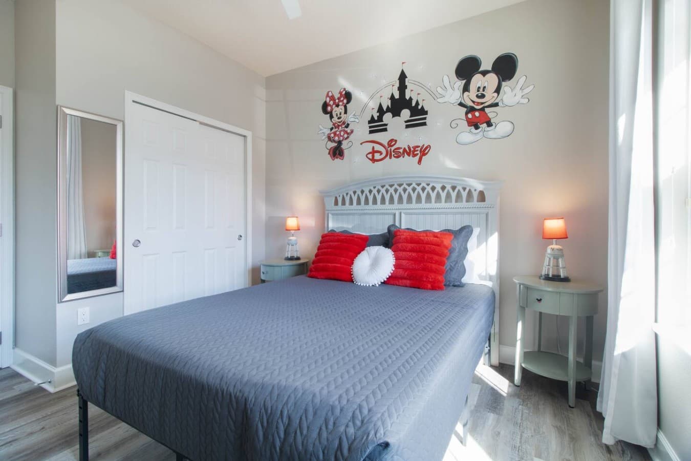 Disney themed bedroom with charming character wall art and stylish furnishings.