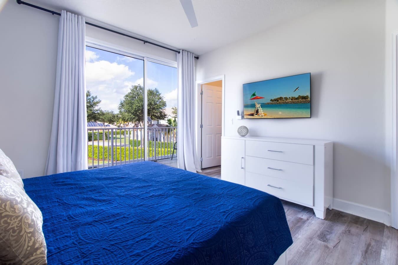 Comfortable bedroom retreat with abundant natural light and stylish furnishings.