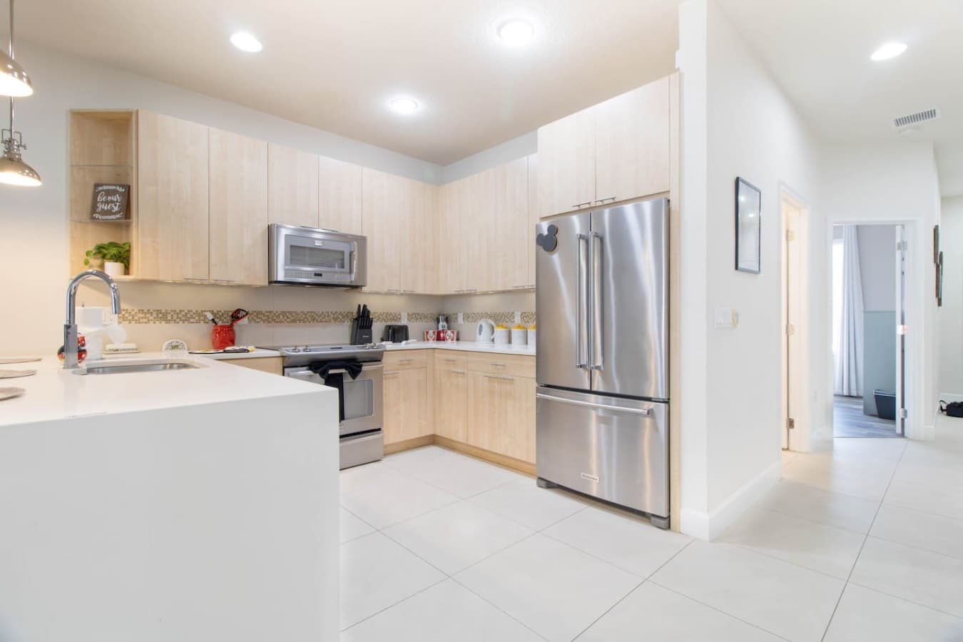 Modern kitchen with stainless steel appliances and ample cabinet storage.