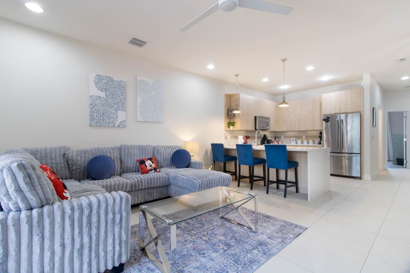 Open concept living and dining area flowing seamlessly into the modern kitchen.